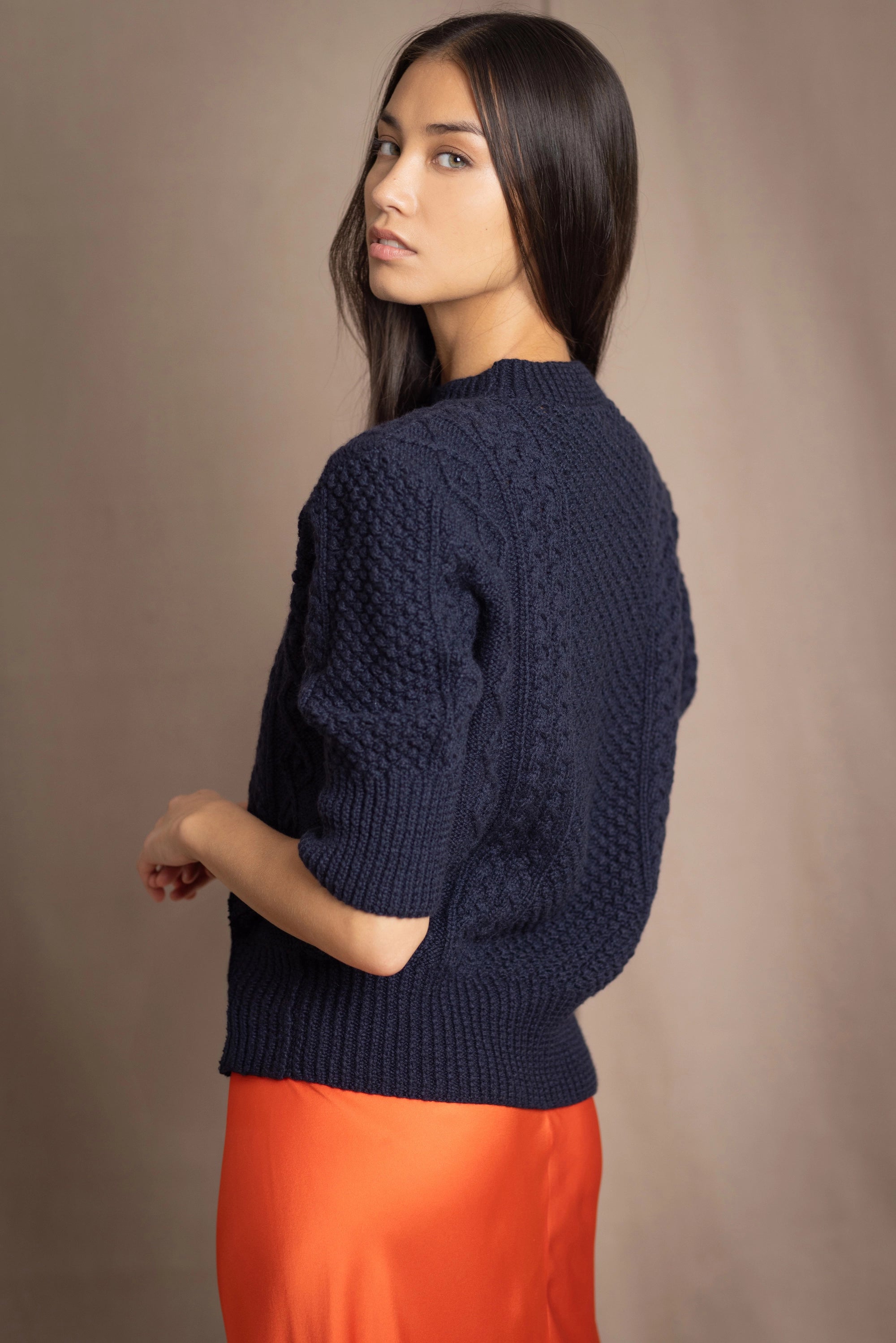 a woman wearing a cashmere aran sweater tee in navy blue