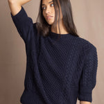 a woman wearing a cashmere aran sweater tee in navy blue