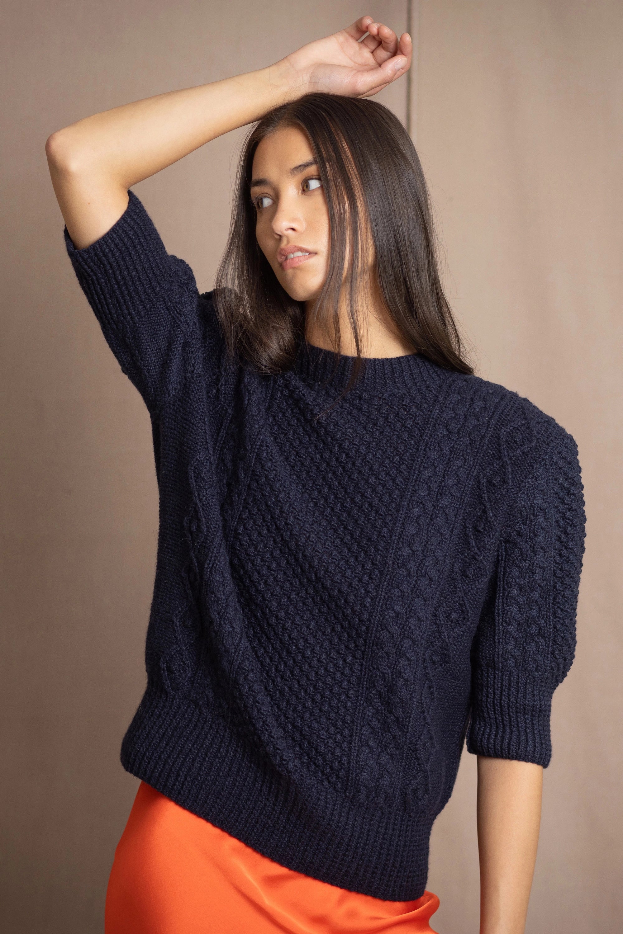 a woman wearing a cashmere aran sweater tee in navy blue