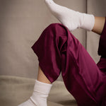 a woman wearing cashmere bed socks in pale pink