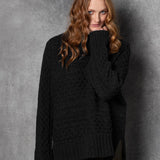 Redhead lady wears pure cashmere aran sweater from Ireland in black