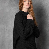 Redhead lady wears pure cashmere aran sweater from Ireland in black