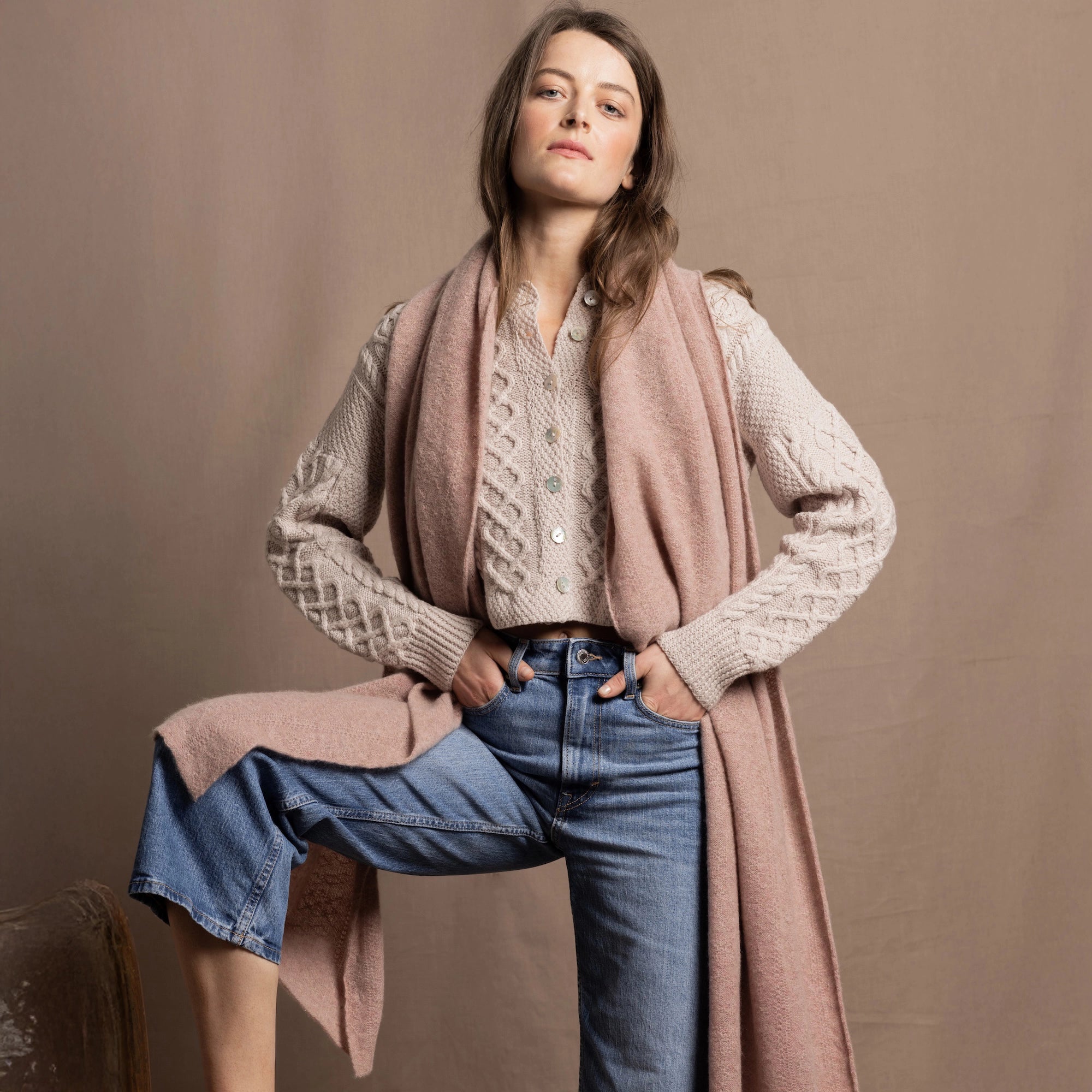 a woman wears a luxury Cashmere Wrap Scarf and Cashmere Aran Sweater Jumper from Ireland