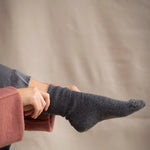 woman wearing cashmere socks in dark grey