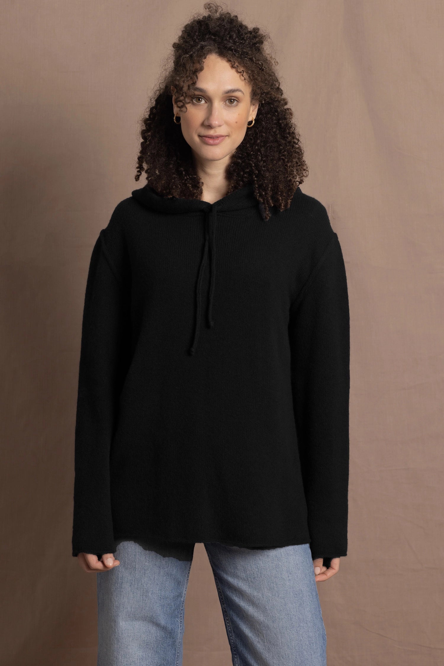 lady wears oversized pure cashmere hoodie sweater in black