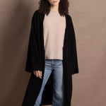 Lady wears luxury cashmere tee sweater in beige with long cashmere kaftan coat over top