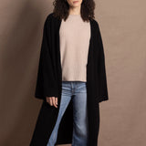 Lady wears luxury cashmere tee sweater in beige with long cashmere kaftan coat over top