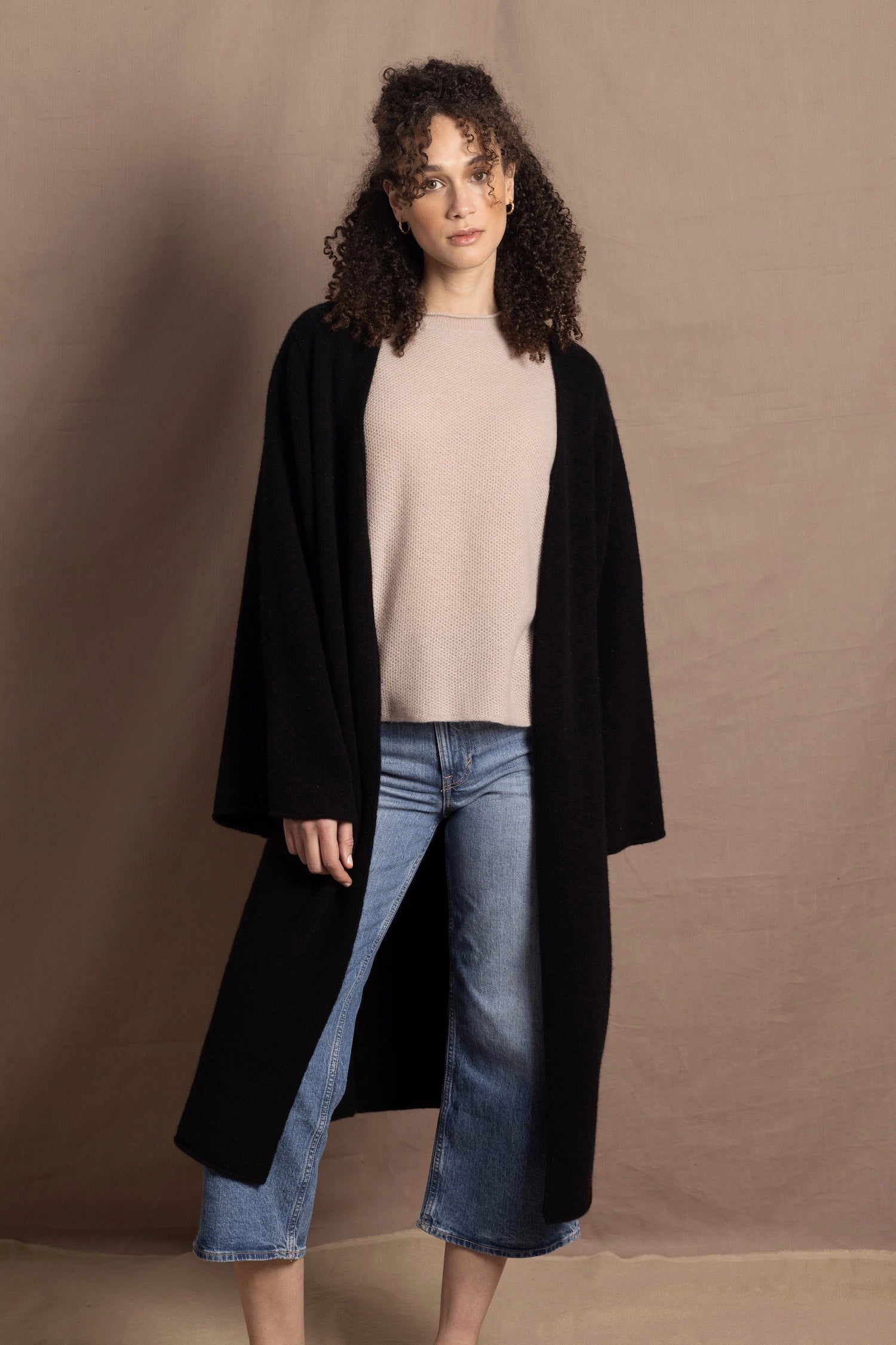 Lady wears luxury cashmere tee sweater in beige with long cashmere kaftan coat over top