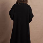 Lady wears luxury cashmere tee sweater in beige with long cashmere kaftan coat over top