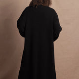 Lady wears luxury cashmere tee sweater in beige with long cashmere kaftan coat over top