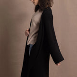 Lady wears luxury cashmere tee sweater in beige with long cashmere kaftan coat over top