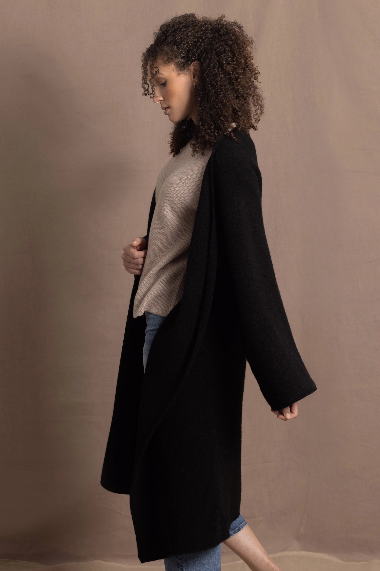 Lady wears luxury cashmere tee sweater in beige with long cashmere kaftan coat over top