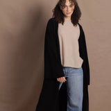Lady wears luxury cashmere tee sweater in beige with long cashmere kaftan coat over top