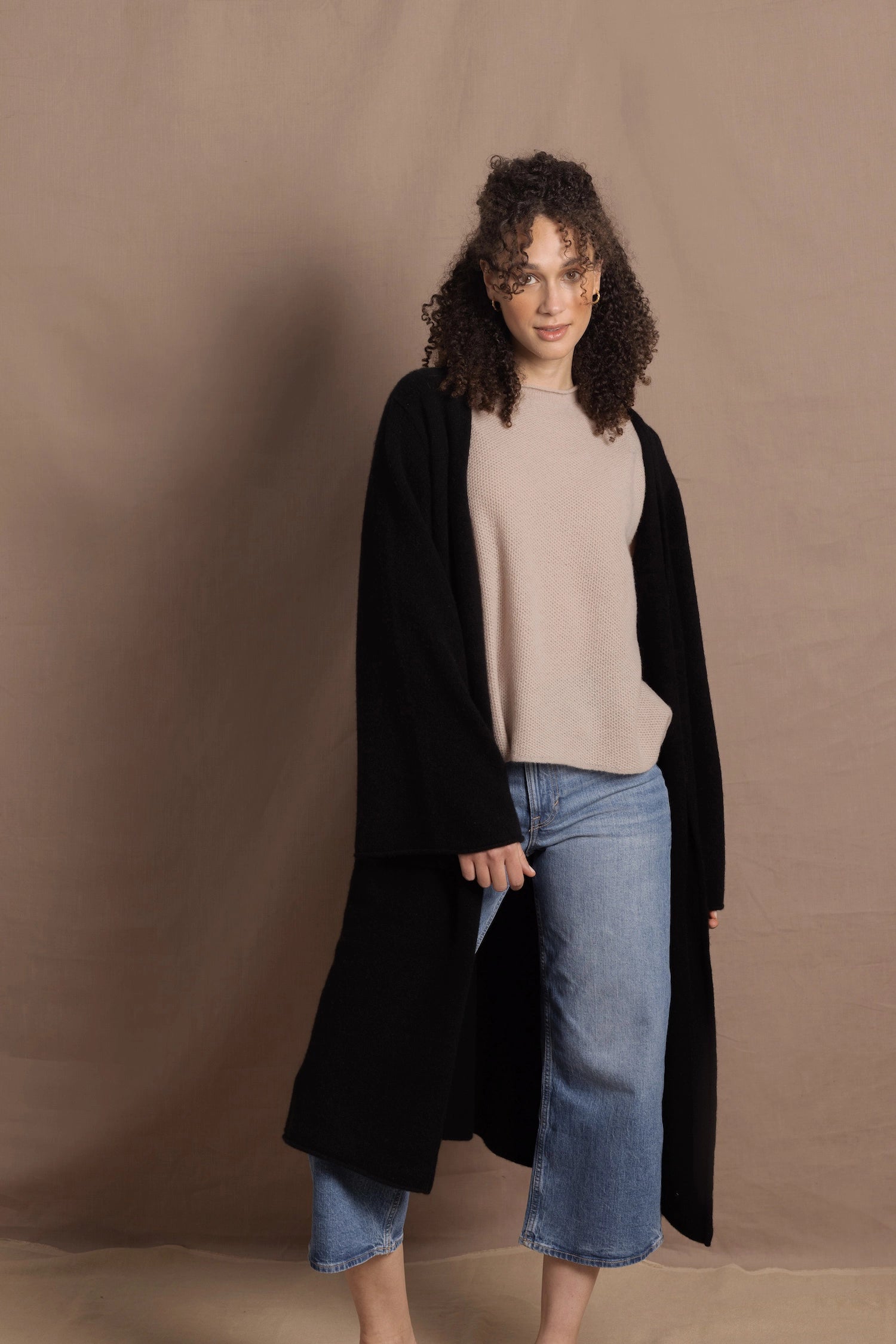 Lady wears luxury cashmere tee sweater in beige with long cashmere kaftan coat over top
