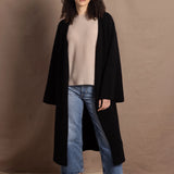 Lady wears luxury cashmere tee sweater in beige with long cashmere kaftan coat over top