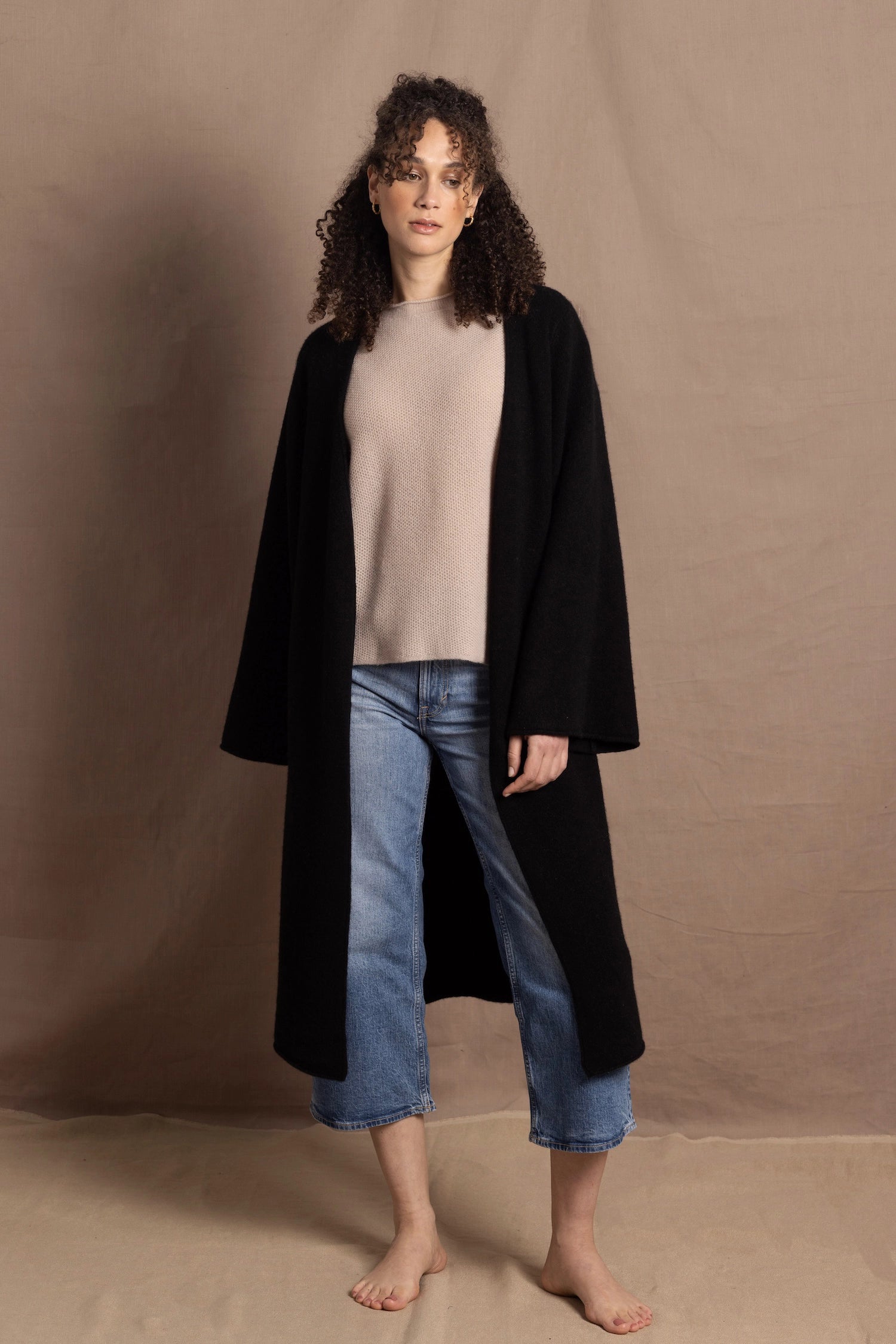 Lady wears luxury cashmere tee sweater in beige with long cashmere kaftan coat over top