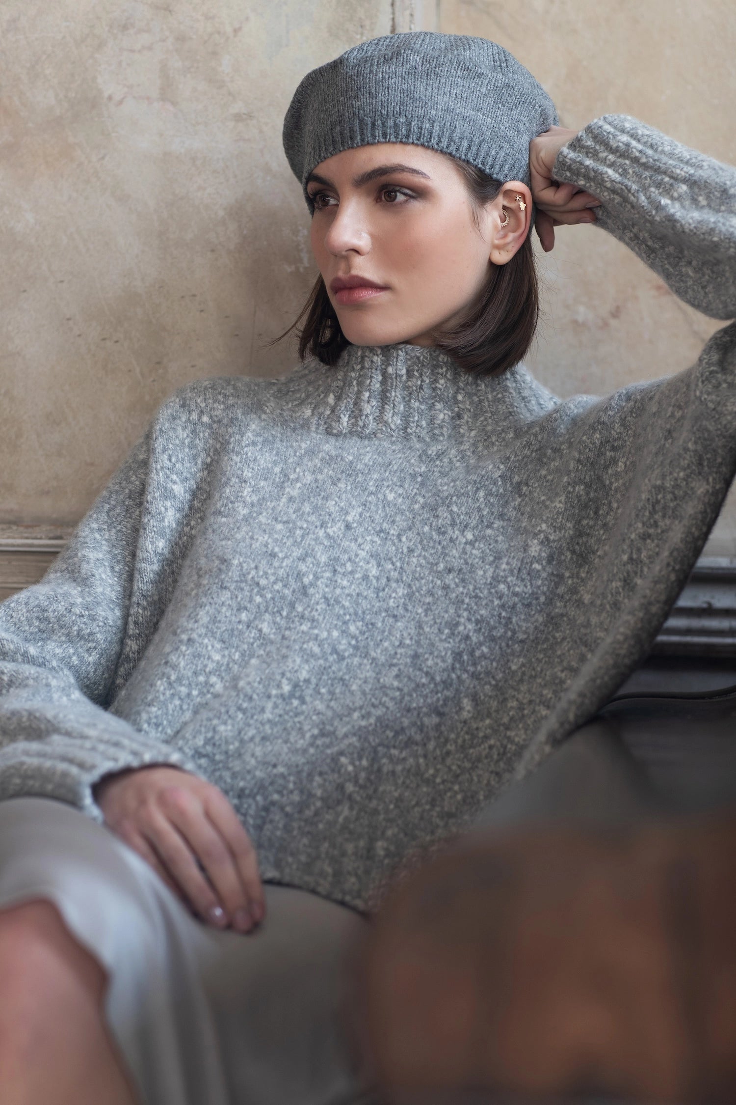 a woman wearing a grey cashmere sweater knit jumper