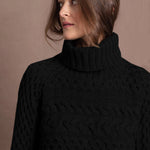 Lady wears pure cashmere aran sweater from Ireland in black