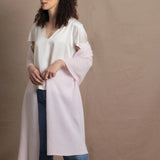 Lady wears large cashmere wrap shawl in pale pink
