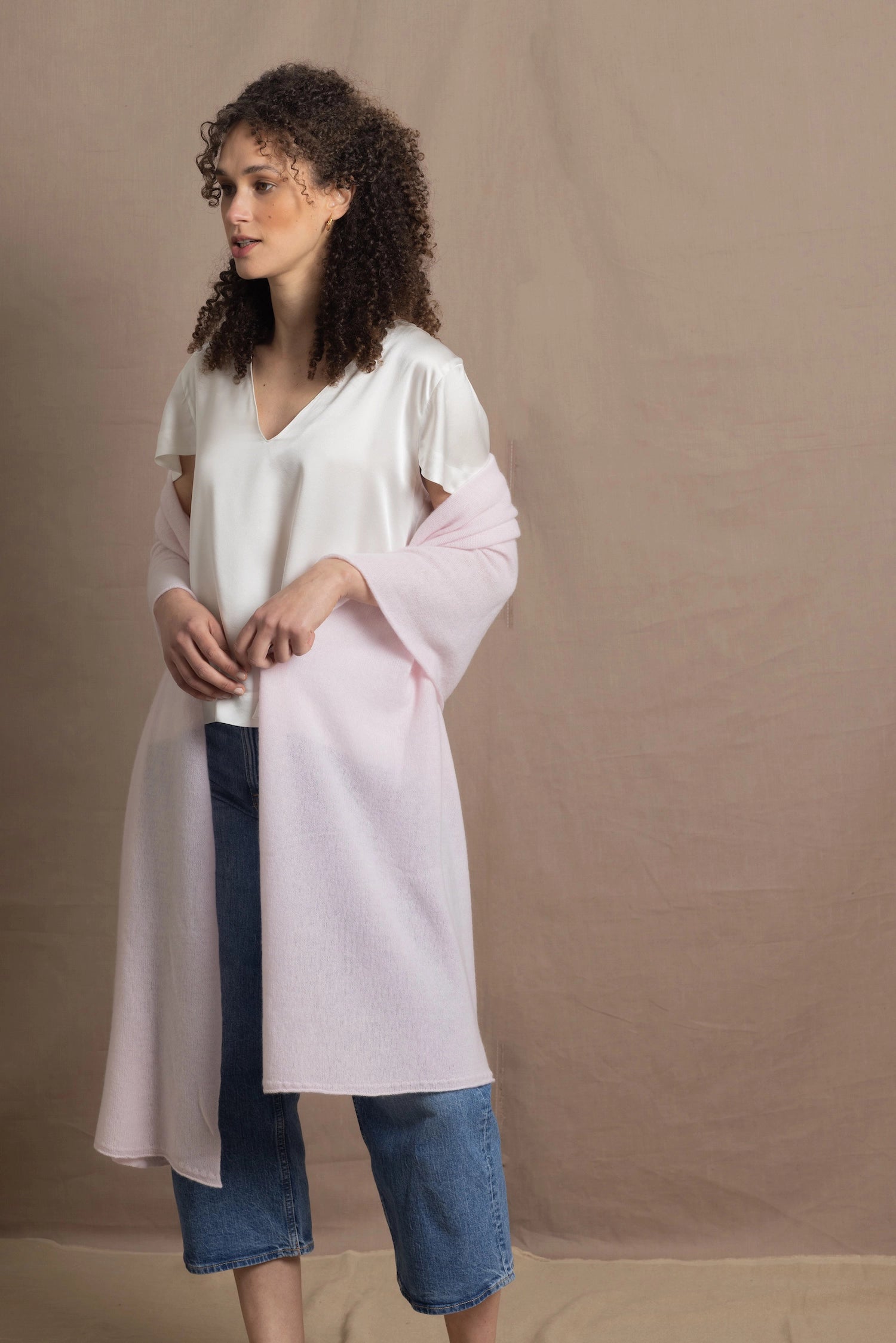 Lady wears large cashmere wrap shawl in pale pink