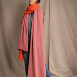 woman wearing a large cashmere wrap shawl in dusty pink rose