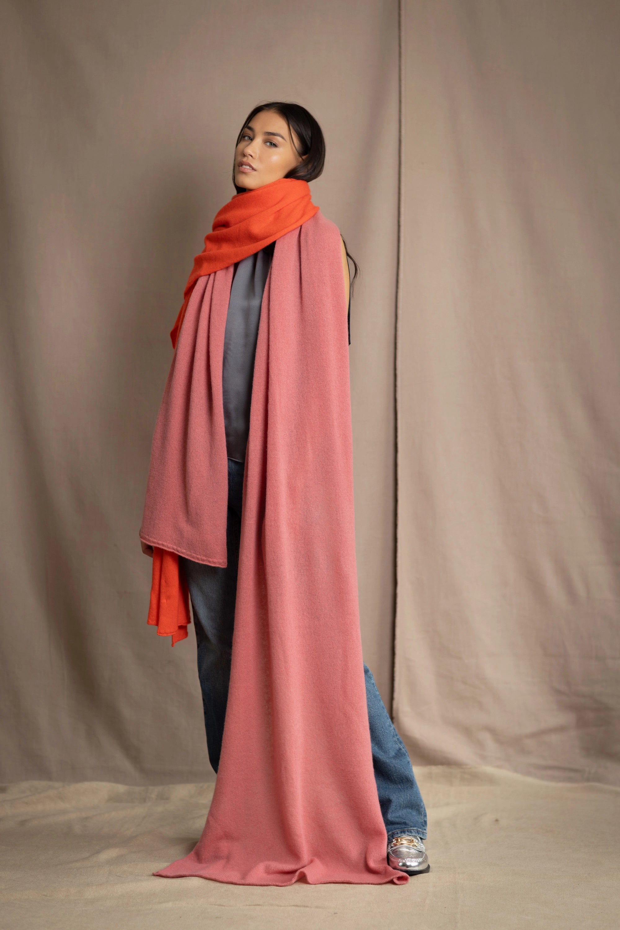 woman wearing a large cashmere wrap shawl in dusty pink rose