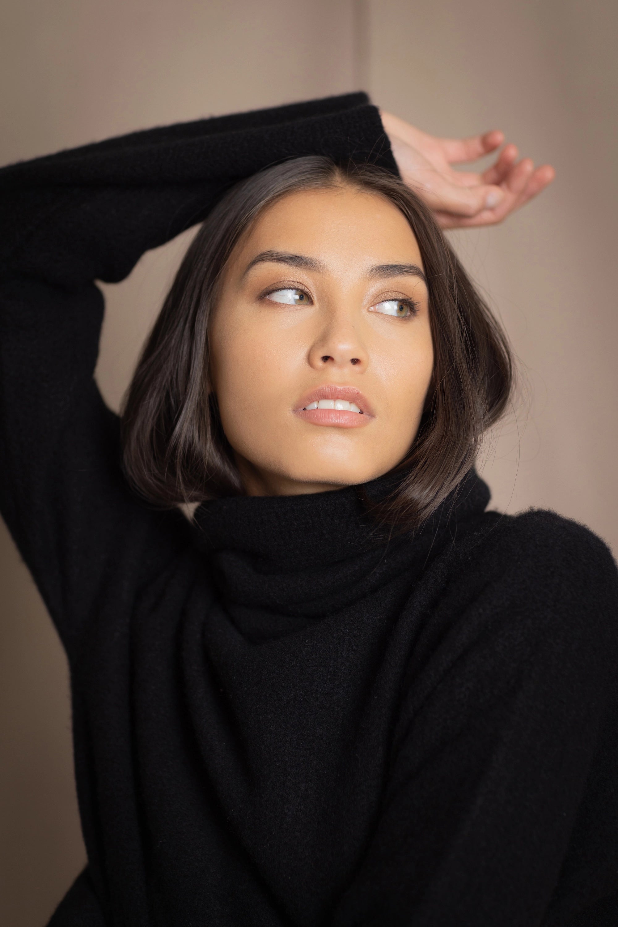 Woman wearing a black cashmere fisherman turtleneck sweater jumper