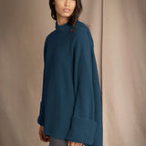 woman wearing oversized teal blue cashmere sweater