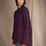 Woman wearing an oversized purple cashmere sweater