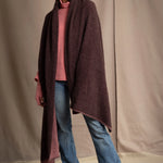 woman wears a long cashmere wrap shawl in dark brown and dusty rose pink with cashmere beanie hat in dusty rose pink