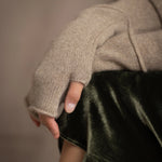 close up of cashmere fingerless gloves in beige with a metallic gold lurex thread through them