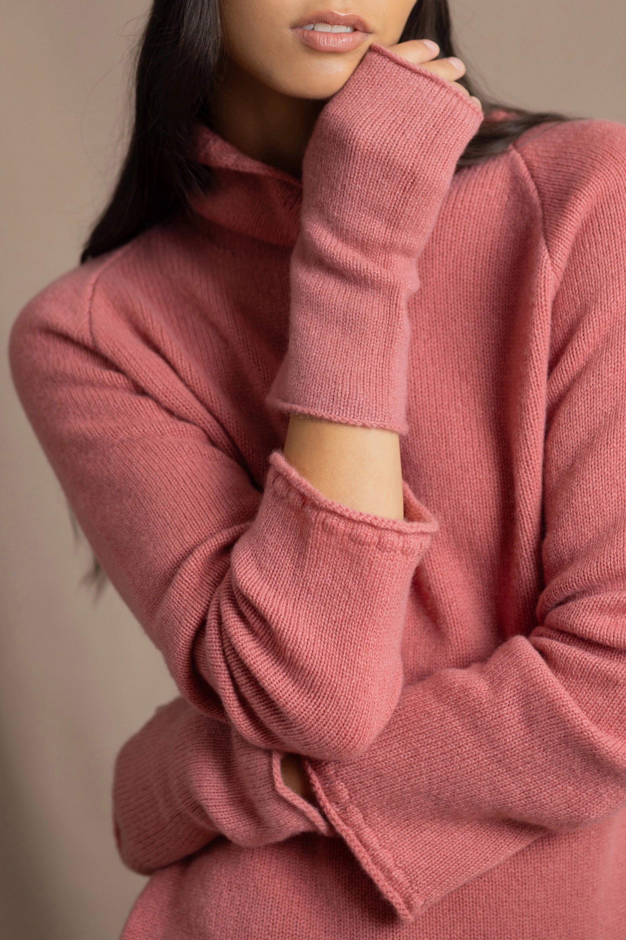 a woman wearing cashmere fingerless gloves in dusty rose pink