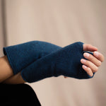 a woman wearing cashmere fingerless gloves in teal