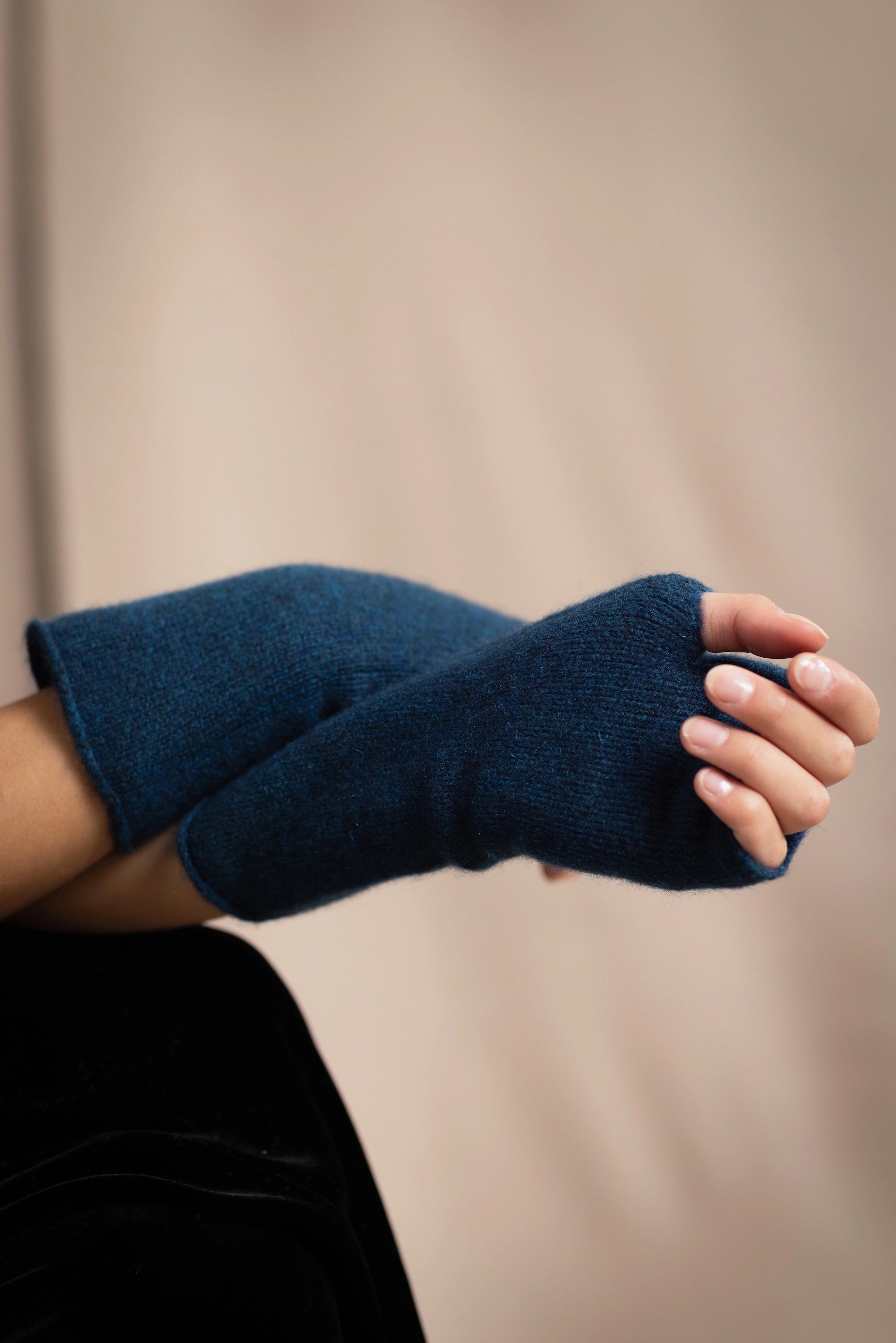 a woman wearing cashmere fingerless gloves in teal