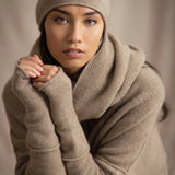 woman wears a cashmere beanie hat in beige with metallic gold lurex thread