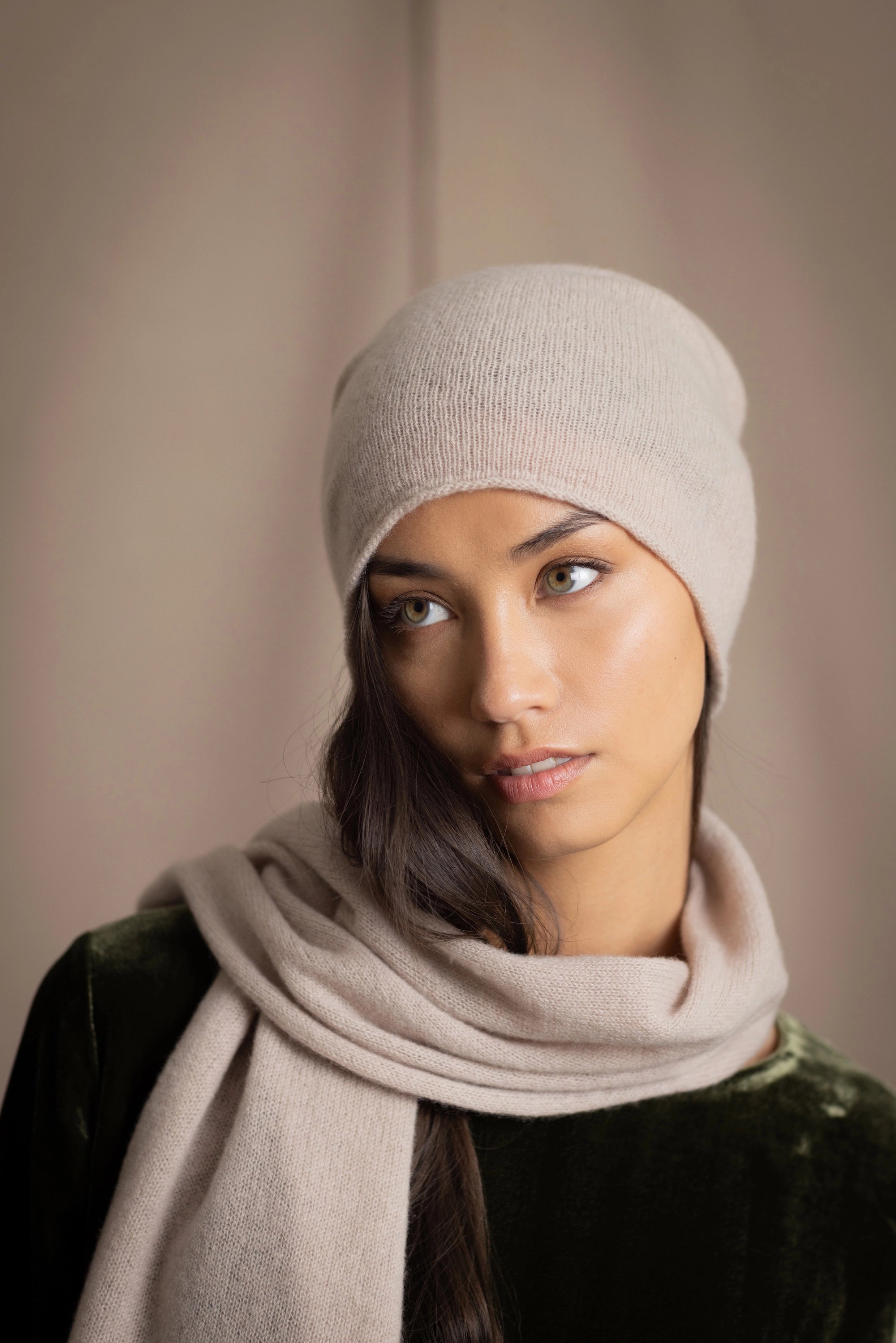 a woman wears a cashmere beanie hat in beige
