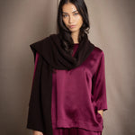 a 3/4 sleeve silk blouse in burgundy with matching trousers and small dark brown cashmere scarf
