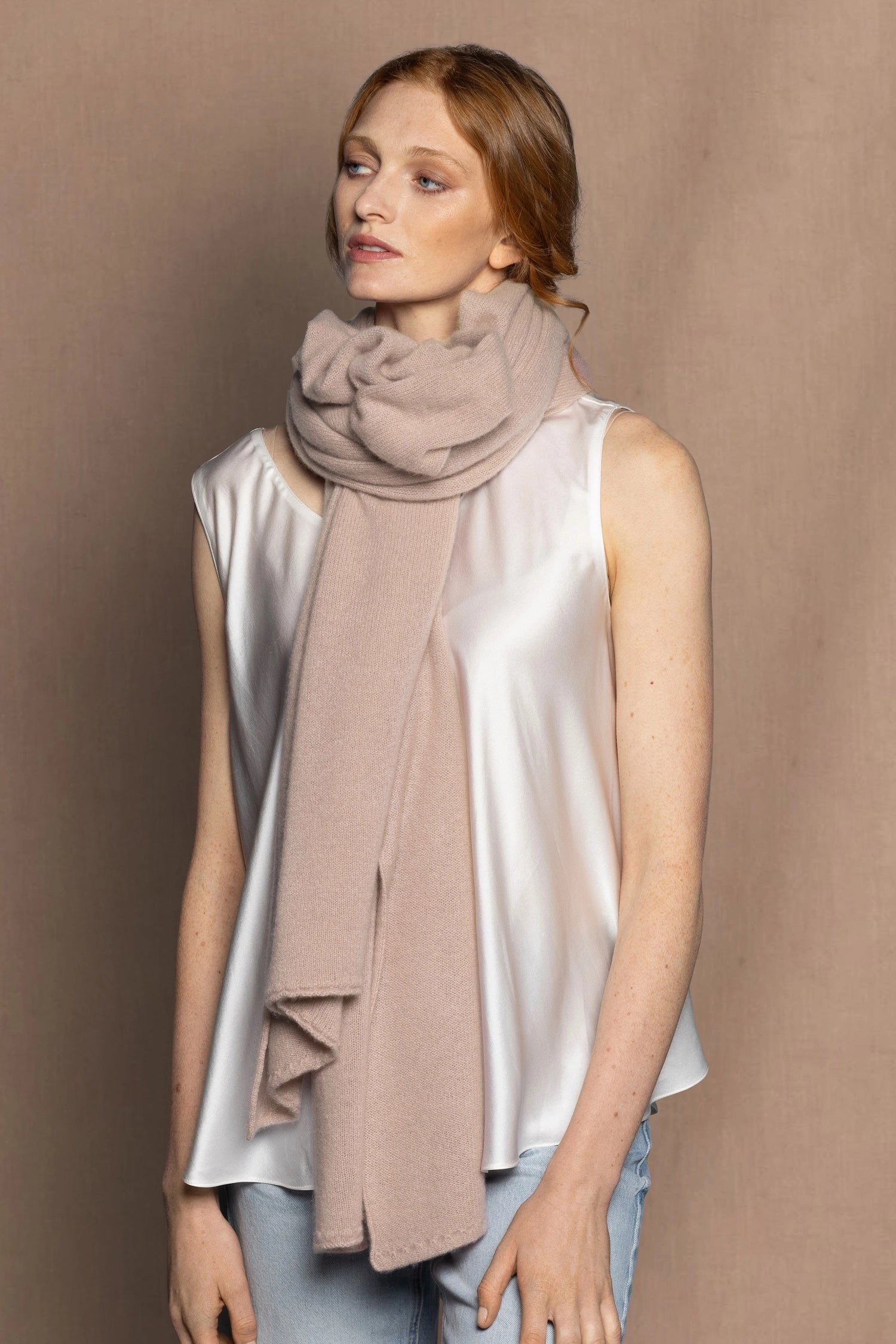 woman wearing a large cashmere wrap shawl in beige colour