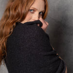 woman wearing sparkling glistening cashmere wrap in black with silver lurex