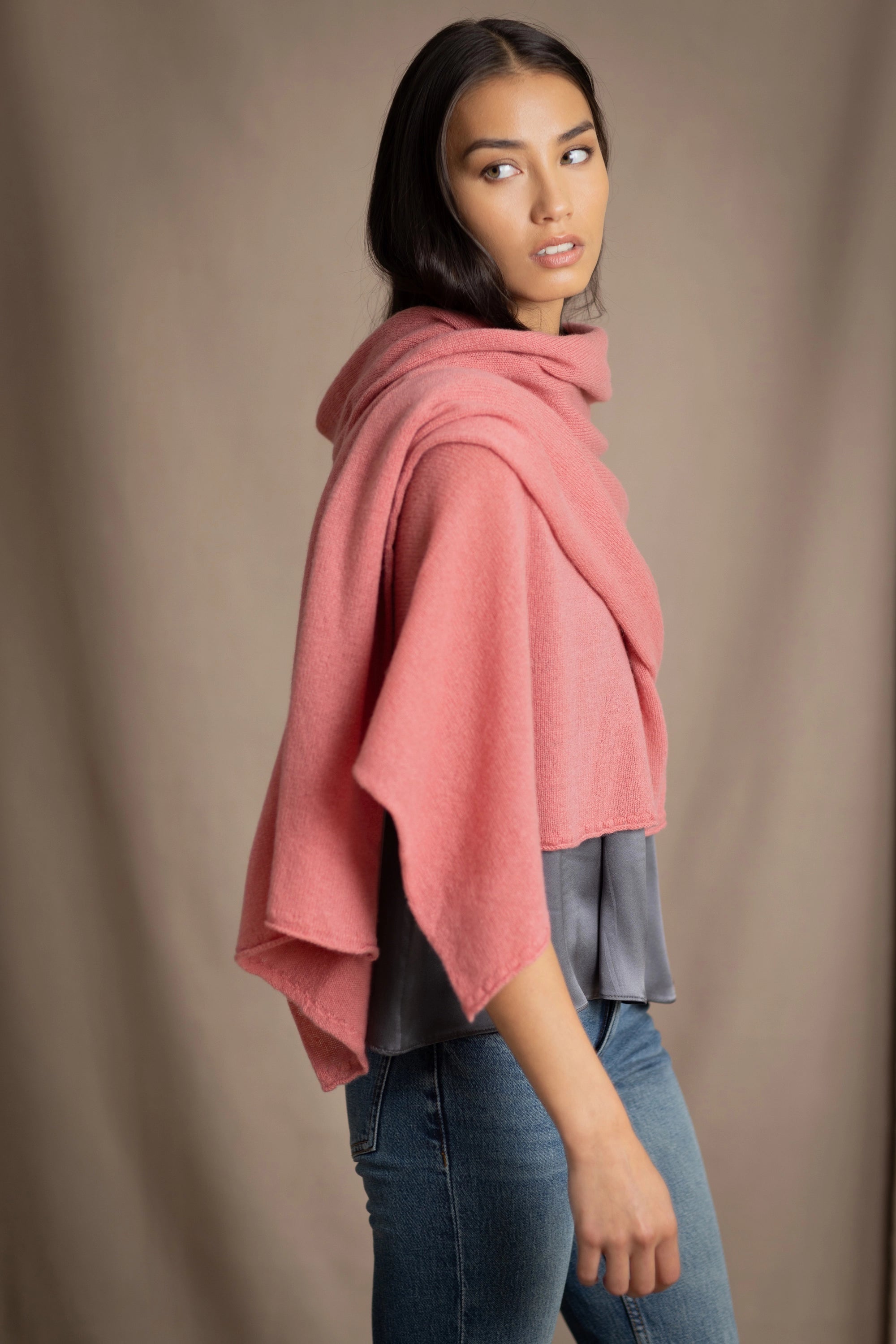 a woman wearing a cashmere wrap scarf in dusty rose pink