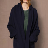 woman wearing ink blue cashmere coat cardigan over green silk dress
