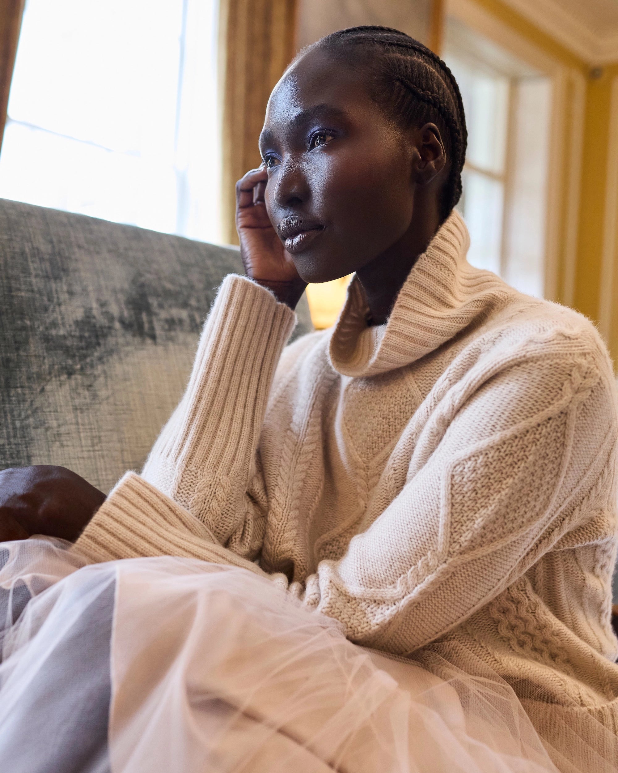 Woman wearing a luxury 100% Cashmere Aran Sweater cable knit Irish jumper in cream