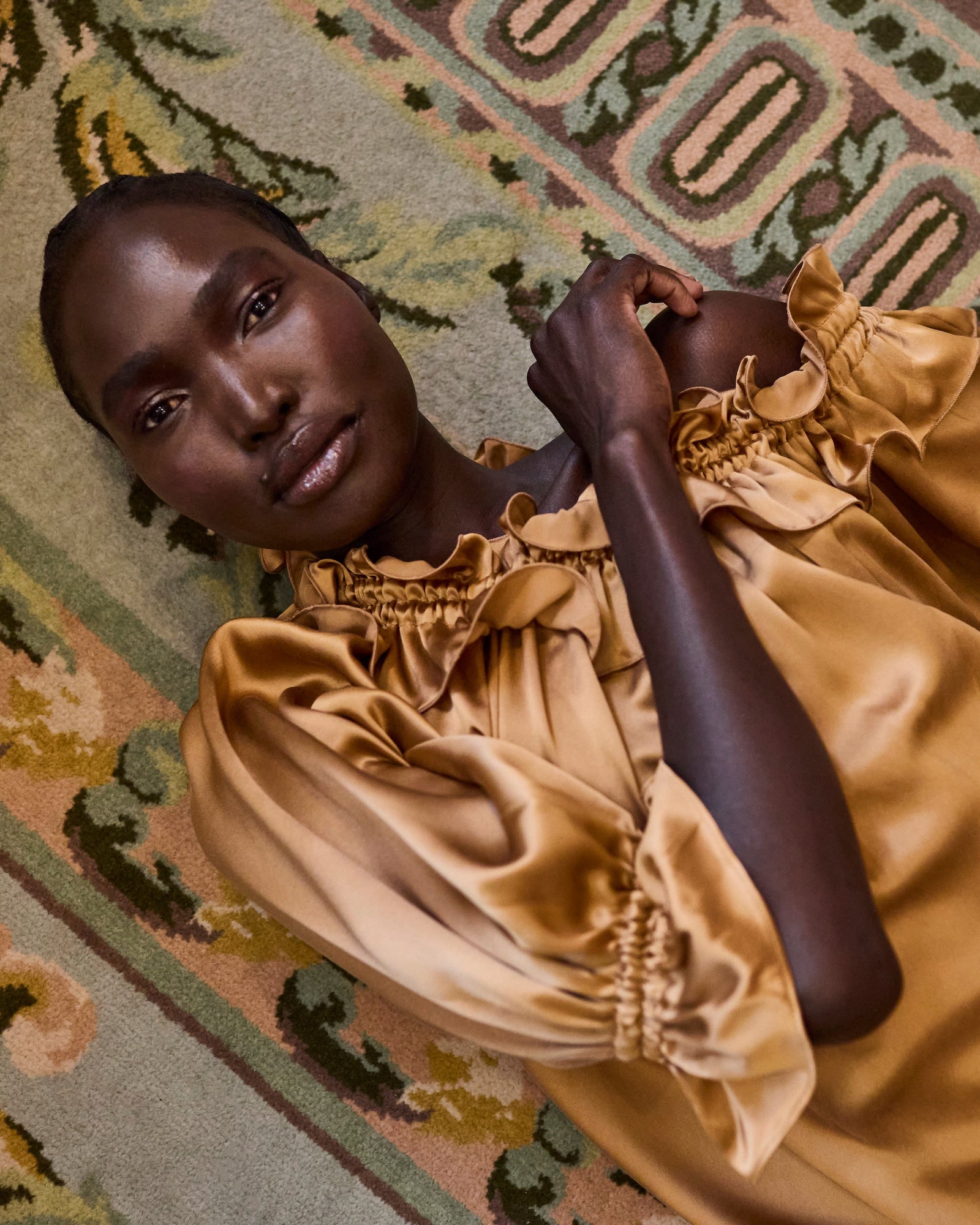 Woman in a gold silk dress