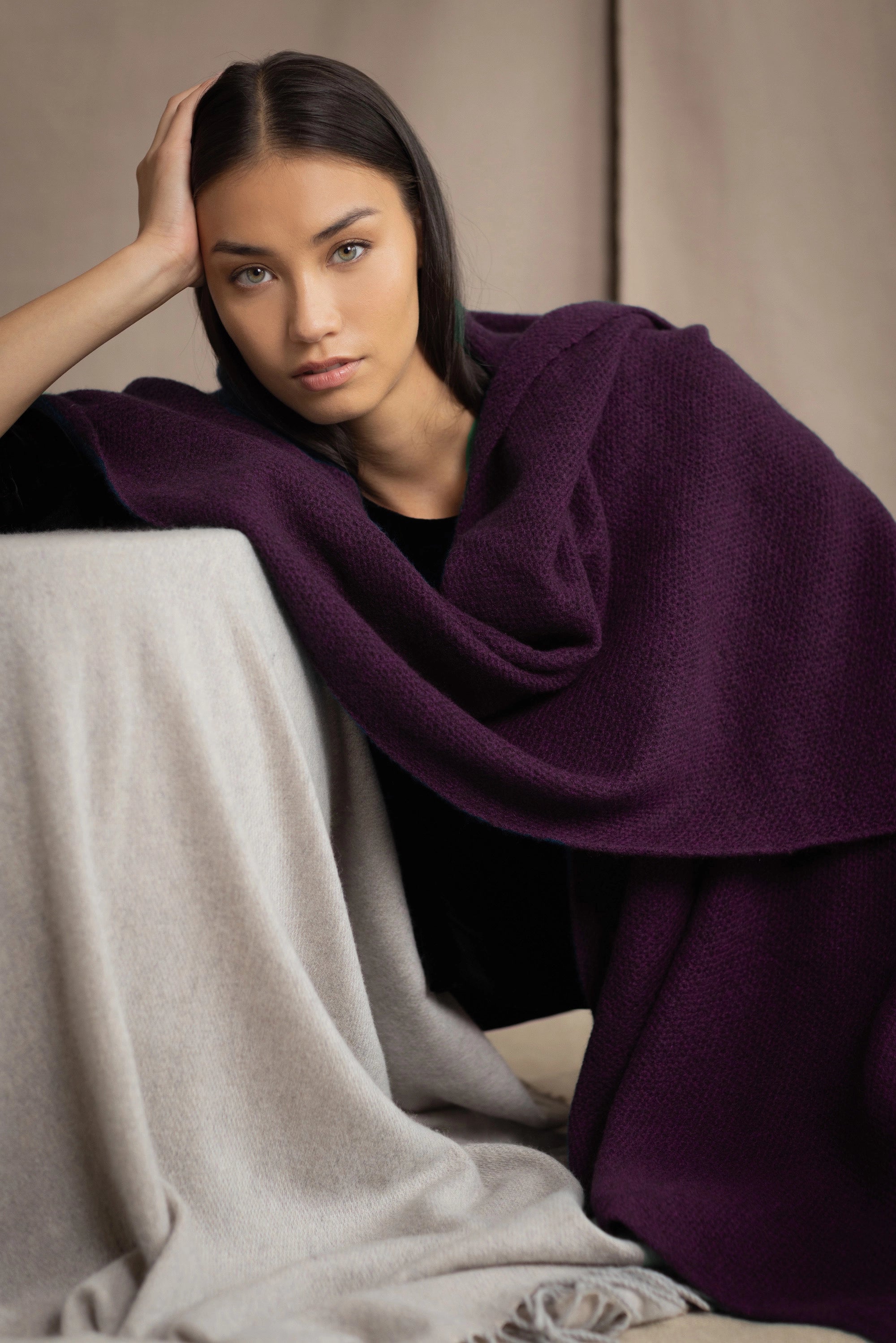 Woman wearing a purple cashmere wrap shawl over a black top