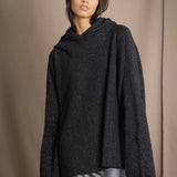 woman wearing an oversized cashmere sweater with hood in black and silver sparkly metallic colour