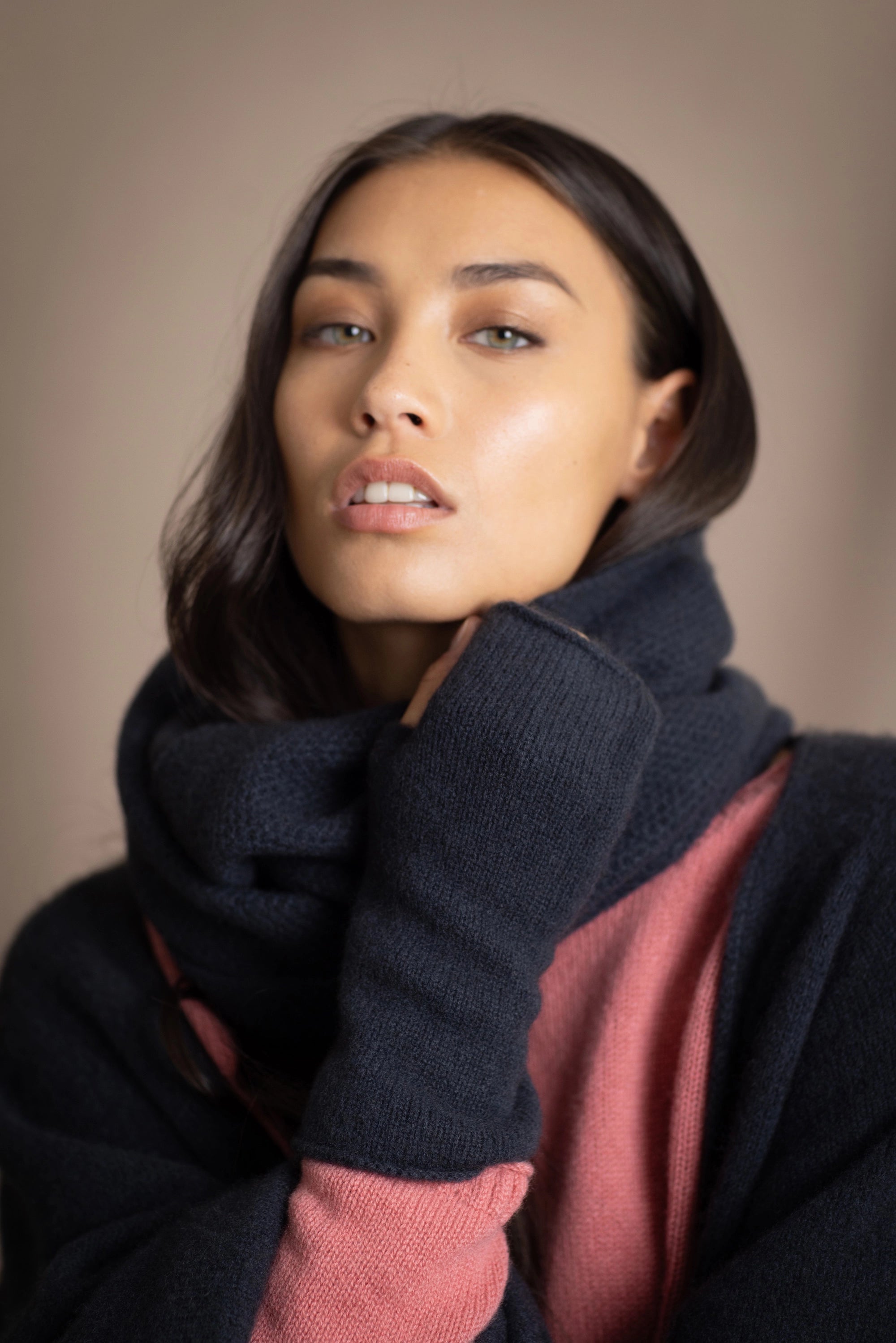 a woman wearing cashmere snood in ink blue with cashmere fingerless gloves