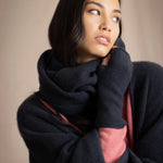 a woman wearing cashmere snood in ink blue with matching fingerless gloves