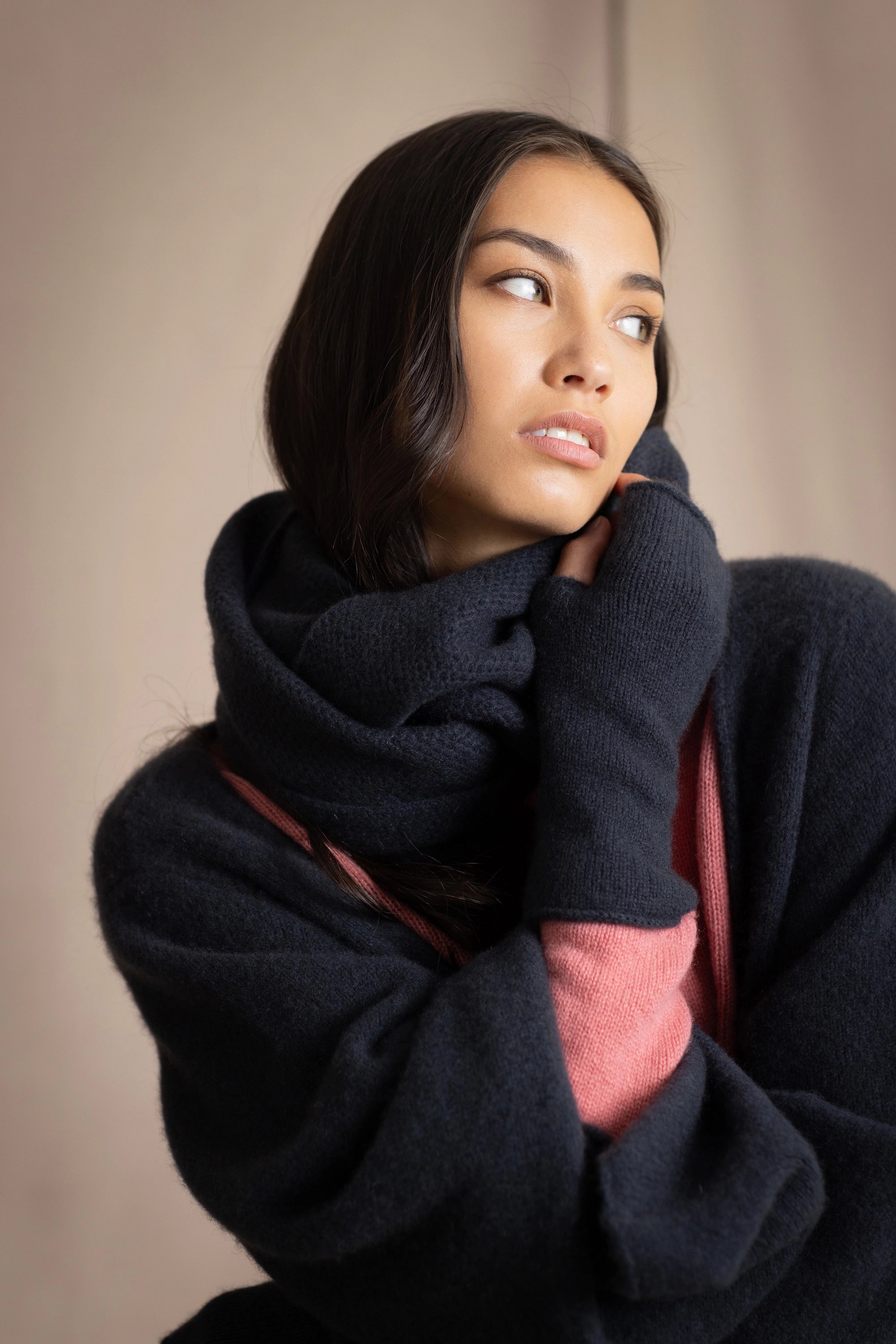 a woman wearing cashmere snood in ink blue with matching fingerless gloves