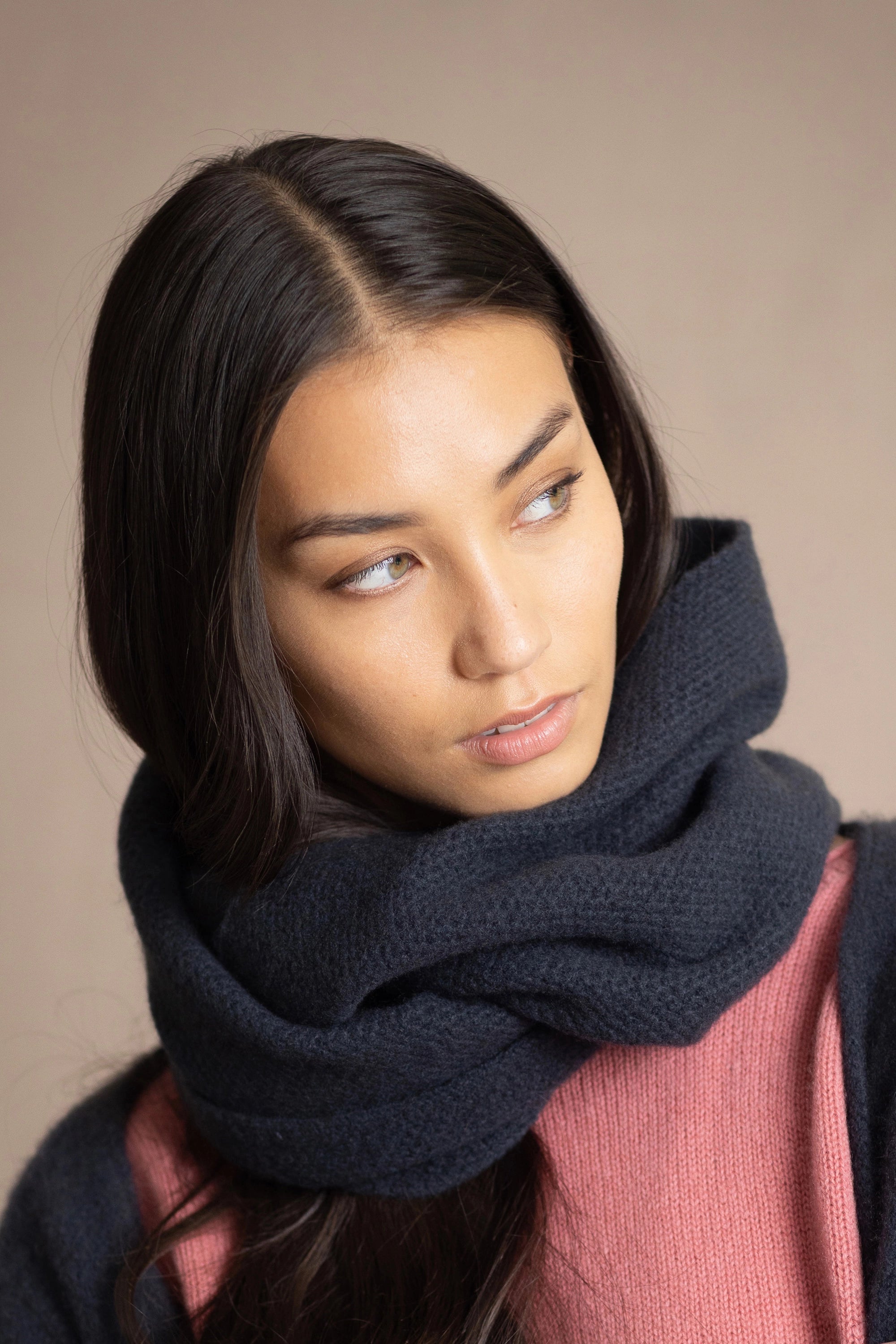 a woman wearing cashmere snood in ink blue