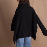 A woman wears an oversized 100% cashmere jumper in black